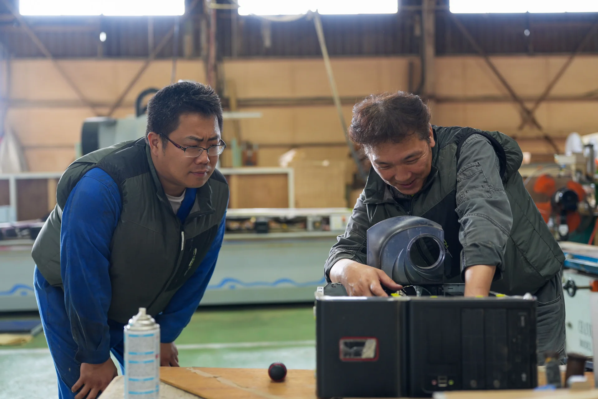 木工機械を前に点検・整備を進めるスタッフ